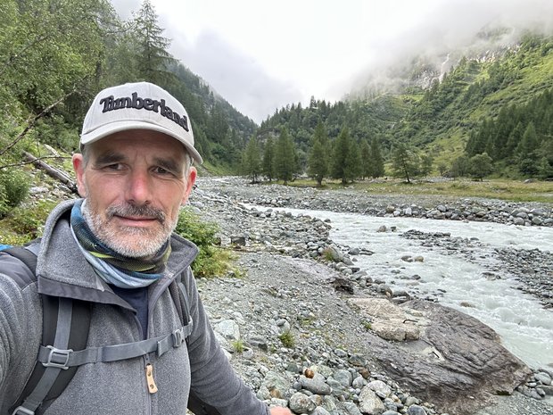Stefan by a mountain stream in a valley.